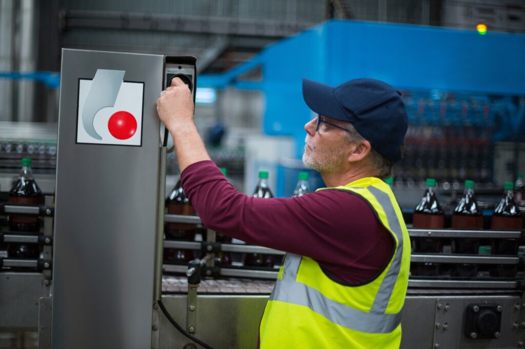 Factory worker operating machine