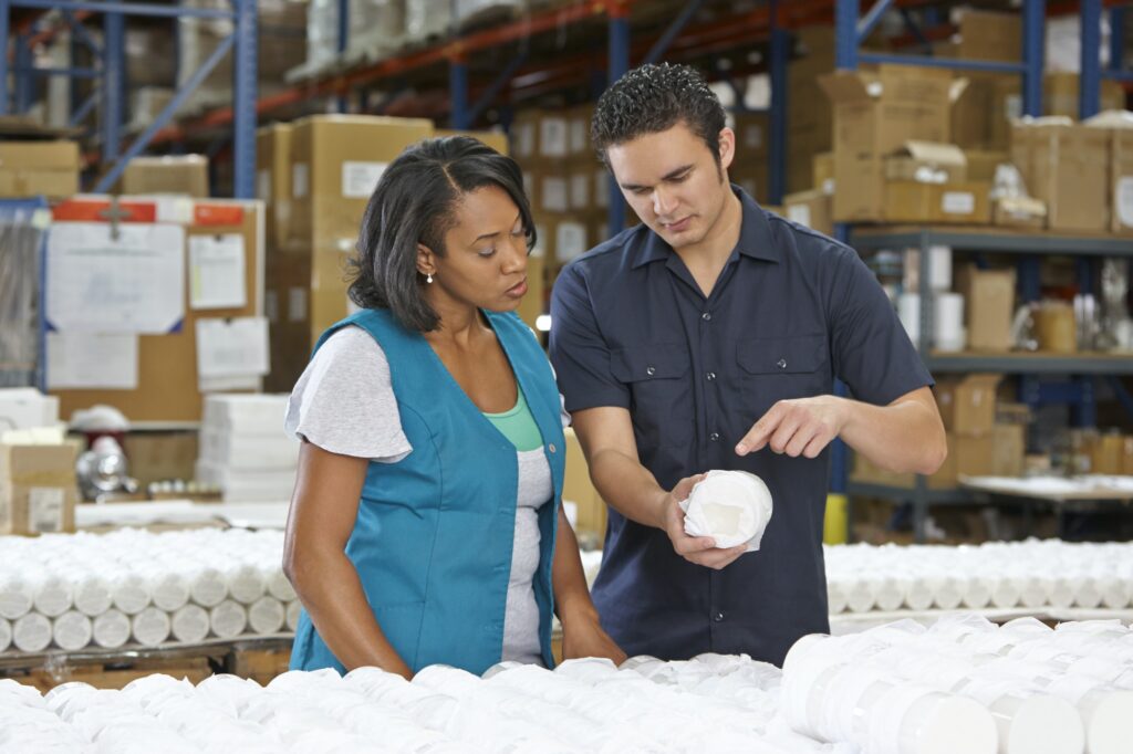 Factory Worker Training Colleague On Production Line