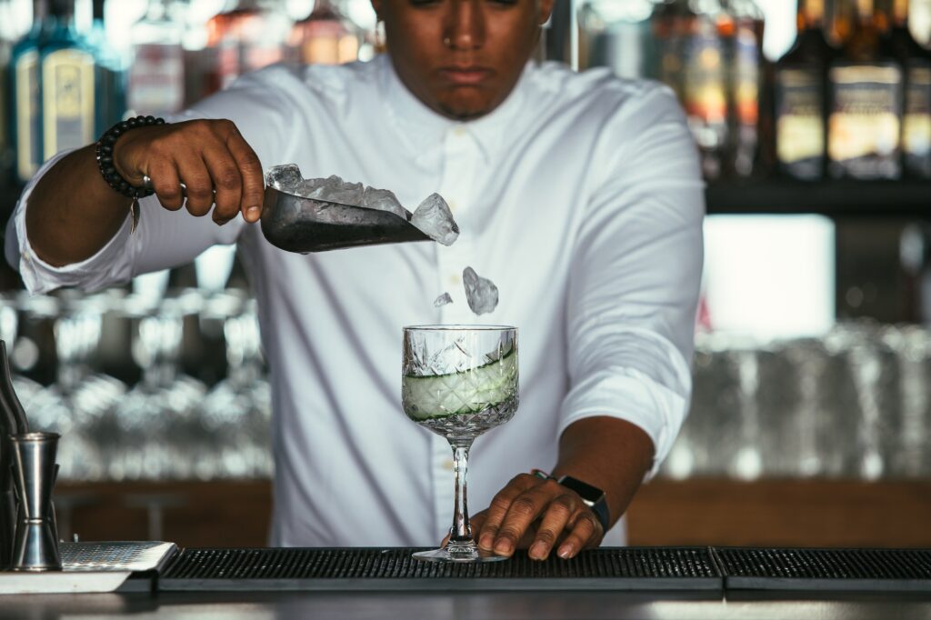 Bartender adding ice