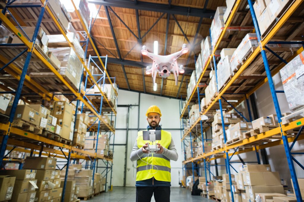 Man with drone in a warehouse.