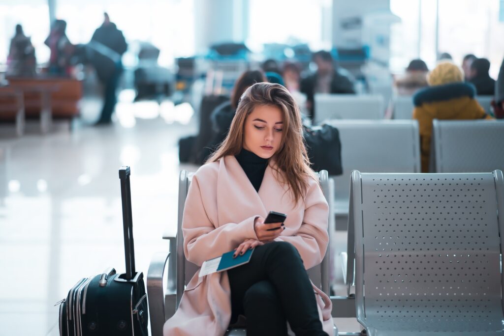 Airport business woman waiting in terminal.