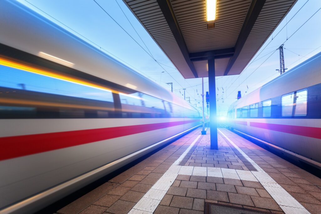 High speed passenger trains on railroad platform in motion