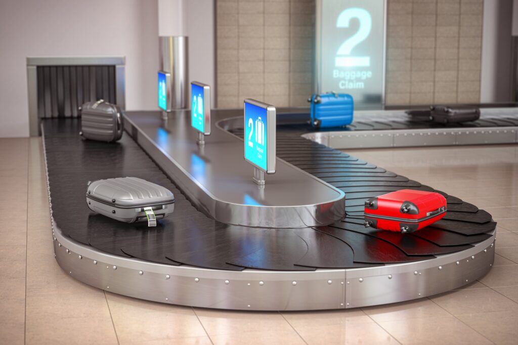 Suitcases on the airport luggage conveyor belt. Baggage claim. A