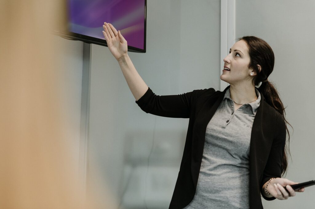 Professor pointing to TV